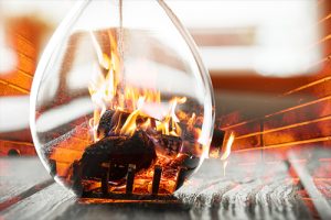 Hourglass over fireplace showing chimney damage happens overtime