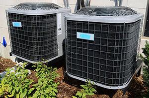 Ocean County air conditioner repair shows two outdoor condensers with brand name blurred