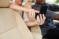 Friends in a car searching for a local spot to eat